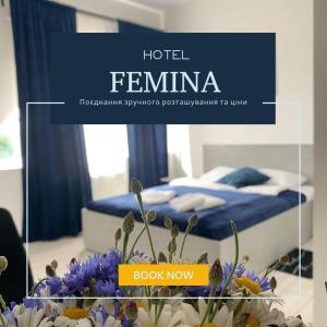 a bedroom with a bed with blue sheets and flowers at Hotel Femina in Zhytomyr