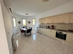 a kitchen with a table and a dining room at Treditto House - Ground Floor residence C1 in Koskinou