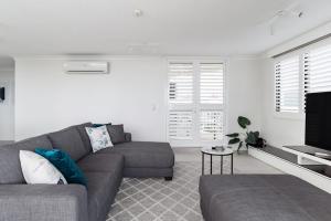 a living room with a couch and a table at Aquarius Luxury Apartment in Cairns
