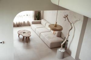 a living room with a white couch and a table at Begin Again Inn in Taitung City