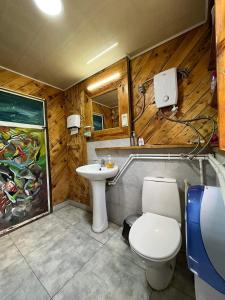 a bathroom with a toilet and a sink at Korsha Guesthouse in Korsha