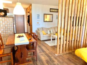 a kitchen and living room with a table and a couch at All’ombra del Miletto in San Massimo