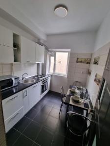 a small kitchen with a table and a dining room at Green Apartment Old Town in Bucharest