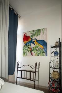 a bedroom with two paintings of birds on the wall at Studio Central in Canet-en-Roussillon