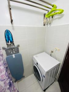 a small bathroom with a toilet and a toaster at Stylish comfy studio and workspace in Cebu City