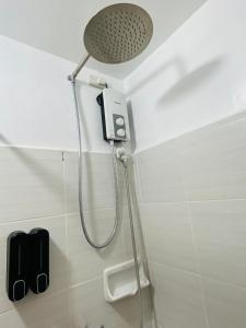 a shower with a shower head in a bathroom at Stylish comfy studio and workspace in Cebu City
