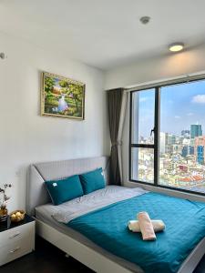 a bedroom with a bed and a large window at Grand SaiGon Centre - RiverGate Residence, Free Gym&Pool in Ho Chi Minh City