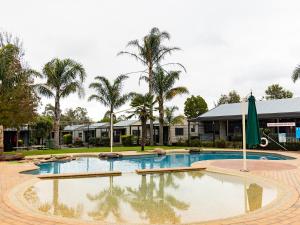 a pool at a resort with palm trees at NRMA Ballarat Holiday Park in Ballarat