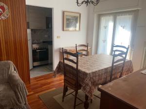 a kitchen and dining room with a table and chairs at Sunny two room apartment in Campo Carlo Magno in Madonna di Campiglio