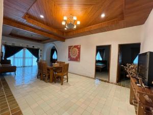 a living room with a table and a dining room at Green Tree Resort กรีนทรี รีสอร์ต in Ban Nong Ho