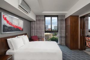 a hotel room with a white bed and a window at Crowne Plaza - Dar Es Salaam, an IHG Hotel in Dar es Salaam