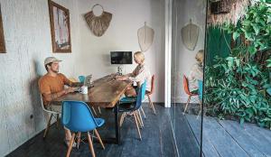 a man and a woman sitting at a table with a laptop at The Green Room Seminyak in Seminyak +45 photos
