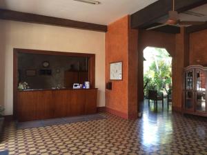 a lobby with a reception desk in a building at Hotel Fenix in Tapachula