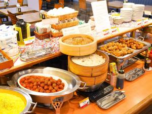 a buffet with many different types of food on a counter at Route Inn Grantia Ishigaki in Ishigaki Island