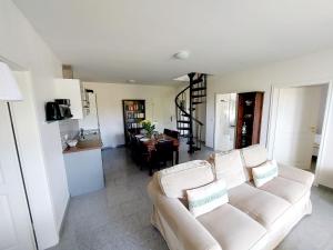 a living room with a white couch and a table at Hochwertige Ferienwohnung direkt am Hafen mit Balkon in Ostseebad Karlshagen