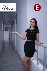 a woman in a black dress standing next to a railing at Hospedaje 4Hera in Satipo