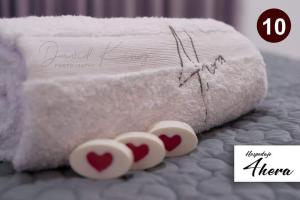 a stack of towels with two hearts on them at Hospedaje 4Hera in Satipo