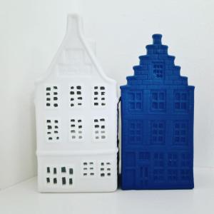 two toy buildings are sitting next to each other at LIEV Amsterdam Cozy boutique suite in The Pijp in Amsterdam