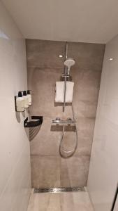 a bathroom with a shower with a towel at LIEV Amsterdam Cozy boutique suite in The Pijp in Amsterdam