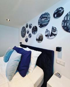 a bedroom with black and white plates on the wall at LIEV Amsterdam Cozy boutique suite in The Pijp in Amsterdam