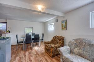 a living room with a table and chairs at Plitvice Lakes House By The Creek - Happy Rentals in Korenica