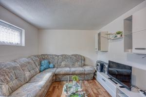 a living room with a couch and a table at Plitvice Lakes House By The Creek - Happy Rentals in Korenica