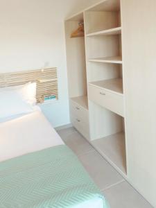 a bedroom with a bed and a closet at Phileo Villas in Platithriás