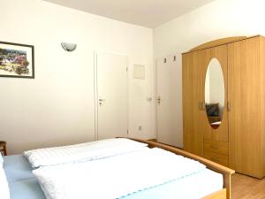a bedroom with a bed and a wooden cabinet at Schlafmütze in Plauen