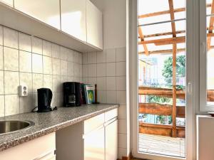 a kitchen with a counter and a sink and a window at Schlafmütze in Plauen