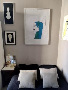 a bedroom with a bed and a picture on the wall at Studio moderne, propre et calme in Melun