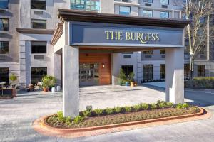 a building with a blue sign that reads the business at The Burgess Hotel, Atlanta, a Tribute Portfolio Hotel in Atlanta