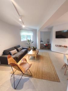 a living room with a couch and a table at The Roundhouse in Paleo Tsifliki