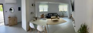 a kitchen and living room with a table and chairs at The Roundhouse in Paleo Tsifliki +1 photo
