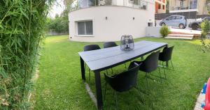 a table in a yard with chairs around it at The Roundhouse in Paleo Tsifliki