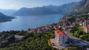 a town on a hill next to a body of water at Apartment Marta 2 in Kotor