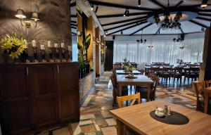 a restaurant with tables and chairs and a dining room at Willa Pirs in Warsaw