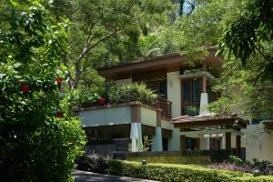 a house with a garden in front of it at Le Méridien Xiamen in Xiamen