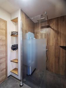 um chuveiro com uma porta de vidro na casa de banho em Baumhaus und Tinyhaus em Felchta