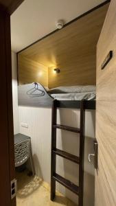 ajar view of a bunk bed in a small room at WORK INN at Taipei 101 in Taipei