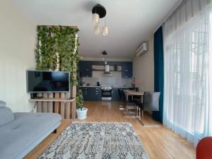Il comprend un salon avec un canapé blanc et une cuisine. dans l'établissement Siera's Penthouse, à Pristina