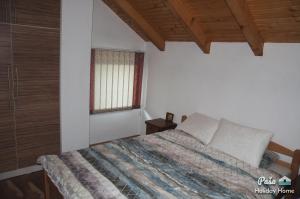 a bedroom with a bed and a window at Holiday Home Paša in Zolaći