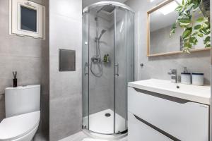 a bathroom with a shower and a toilet and a sink at Cute 1bedroom center apartment in Prague