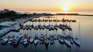 a group of boats docked in a marina at sunset at MaRailiS Port Apart Mangalia in Mangalia