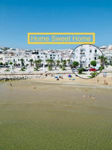 a view of a beach with people on the sand at home sweet home vieste in Vieste