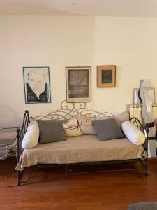 a couch with pillows on it in a living room at Charming house in San Niccolò in Florence