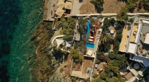 an aerial view of a resort next to the ocean at Pafsilipon Suites in Ermoupoli
