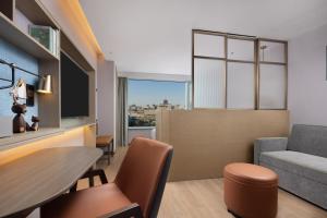 a living room with a table and a couch at Home2 Suites by Hilton Beijing West Station in Beijing