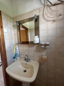 a bathroom with a sink and a mirror at Vrea Home in Nea Vrasna +25 photos