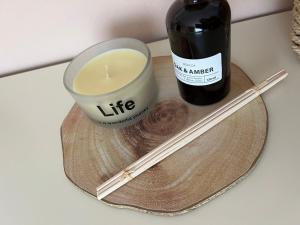 a bottle of wine and a candle and chop sticks at MIQT GUEST HOUSE in Shkodër