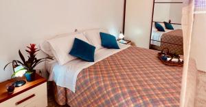 a bedroom with a bed with blue pillows at home sweet home vieste in Vieste +18 photos